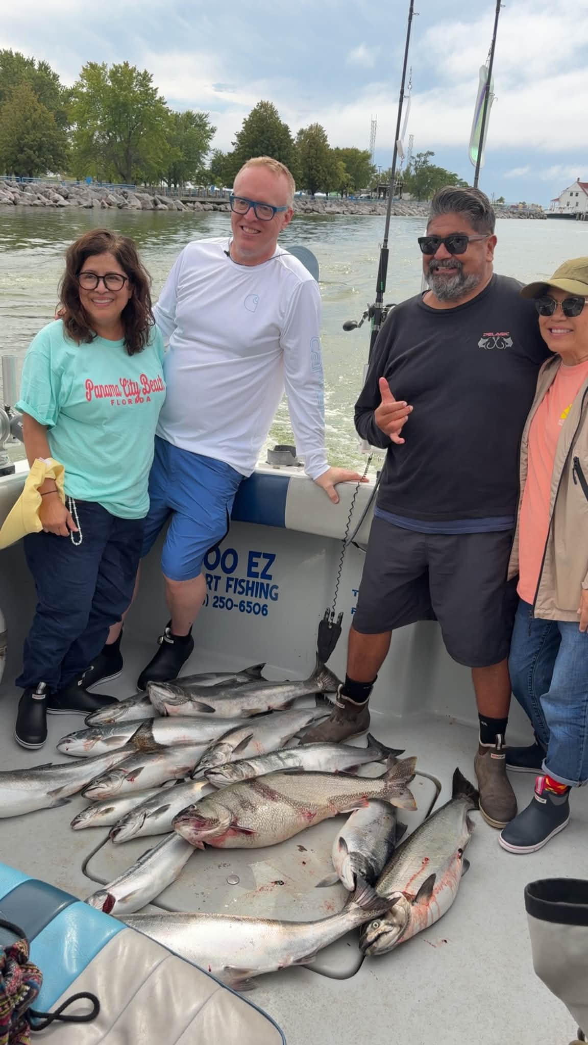 Four happy customers pose with their catch of multiple large fish on the Too Ez Sport Fishing charter boat.